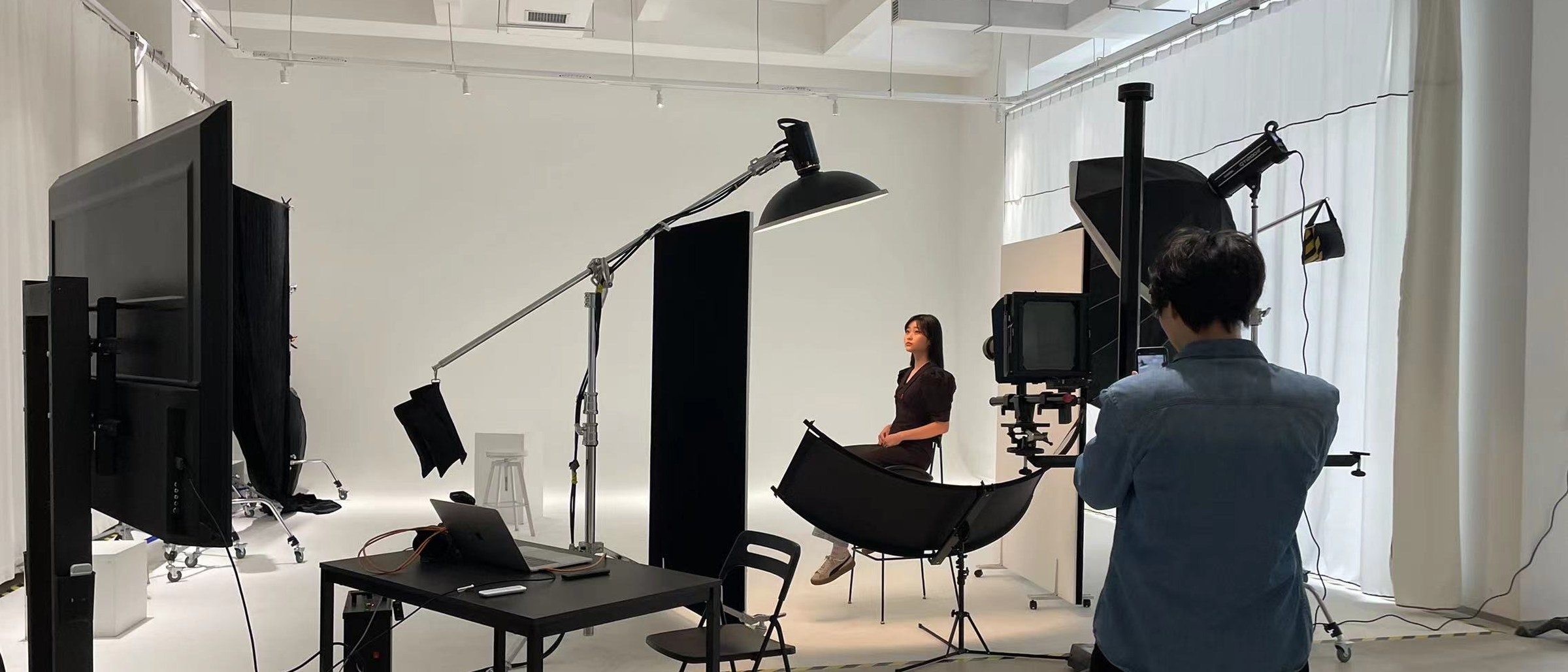Studio set lit by S series power pack with boom-mounted reflector